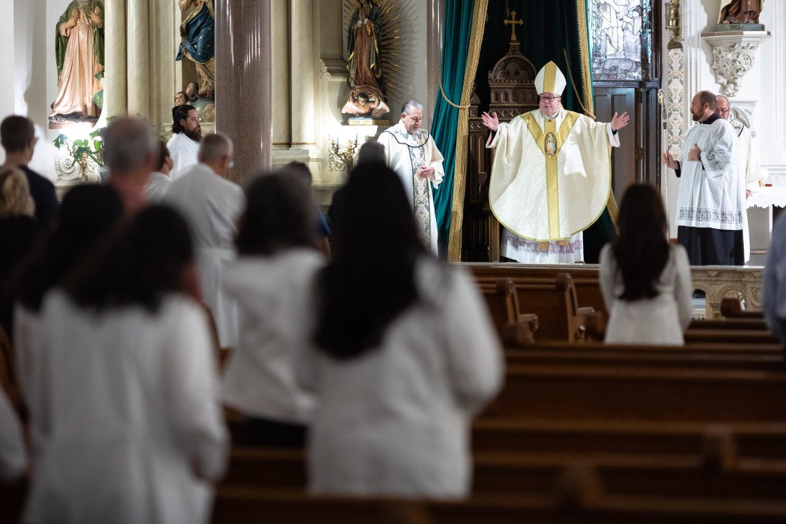 Bishop gives blessing at White Coat Mass